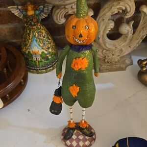 Green and Orange Pumpkin Figurine Holding A Black Cat